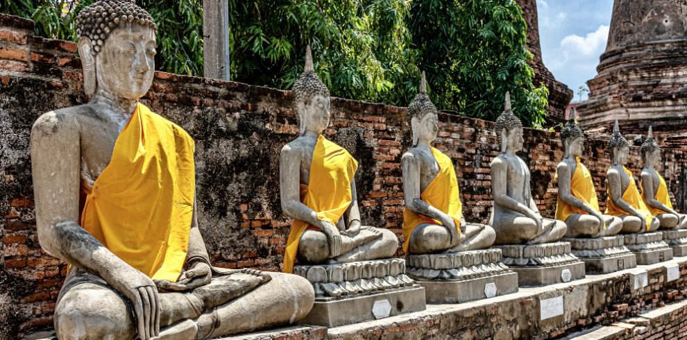 Nepal travel deals row old buddha statues covered with yellow cloth