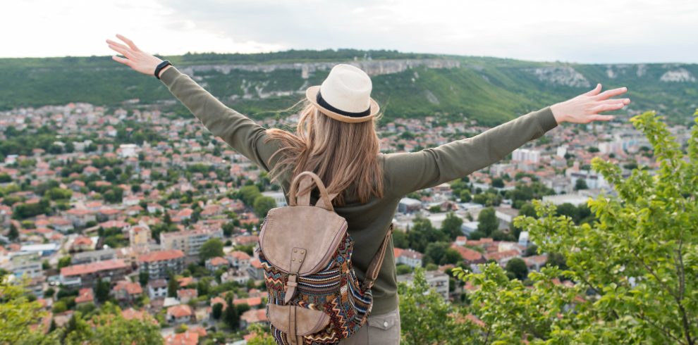 Nepal travel deals back view traveller with hat enjoying holiday