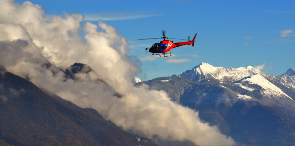 Nepal travel deals helicopter flying among clouds snow capped mountains