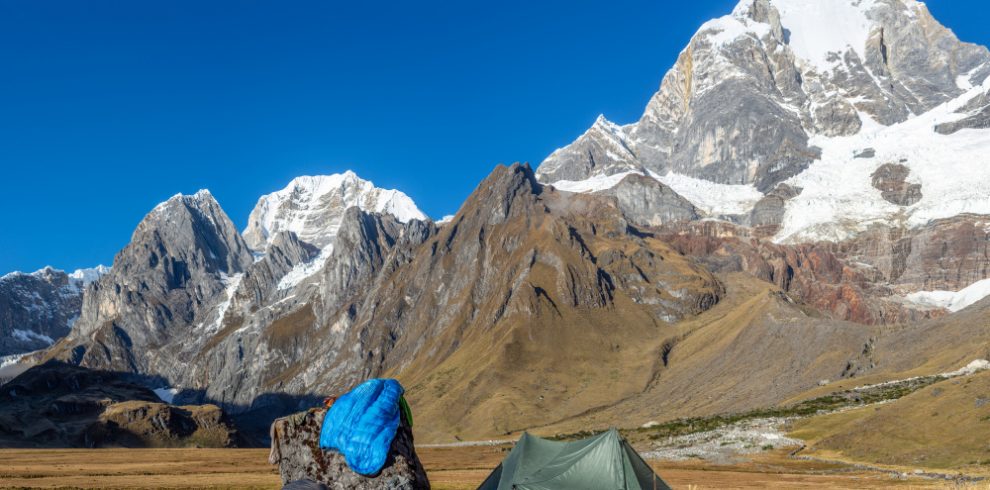 Nepal travel deals landscape shot green tent near rock field surrounded by mountains covered snow